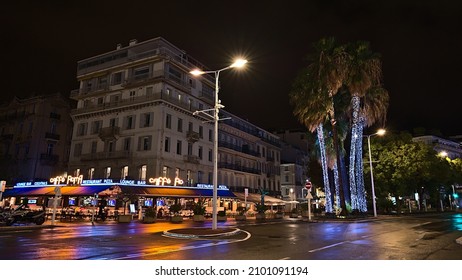 Cannes, Provence-Alpes-Cote D'Azur, France - 11-03-2021: Beautiful Night View Of The Downtown Of Cannes, French Riviera, France With Caffe Roma And Lights Reflected On The Wet Street.