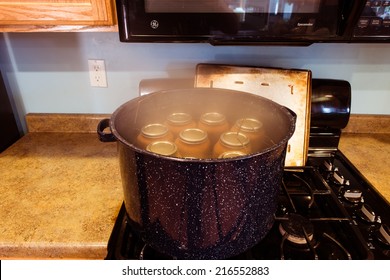 Canning Jars Boiling In  Water To Kill Any Bacteria And Sealing Process.