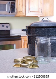 Canning Jars With Lids, Canner Or Pot In A Kitchen Setting