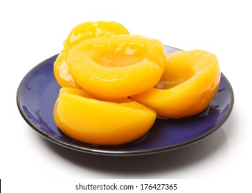 Canning Peaches Isolated On Blue Plate. 