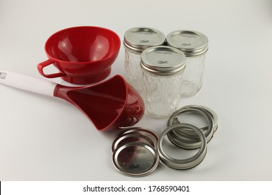 Canning Supplies, Ball Mason Jars, Rings, Lids, Wide Mouth Funnel And Large Red Ladle, Isolated On White Background. Lancashire, UK, 03-07-2020: 