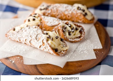 Cannoli. Classic traditional Italian dessert. Italian pastries made with tube-shaped shells of fried pastry dough filled with a sweet, creamy ricotta filling. Traditional Sicilian dessert.