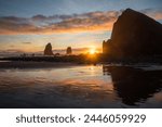 Cannon Beach, beach sunset, Oregon, pnw, pacific northwest, USA, famous beach, coastal landscape, reflection, beach rocks, golden hour on the coast, warm light, sunshine, holidays