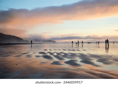 Cannon Beach, beach sunset, Oregon, pnw, pacific northwest, USA, famous beach, coastal landscape, reflection, beach rocks, golden hour on the coast, warm light, sunshine, holidays - Powered by Shutterstock