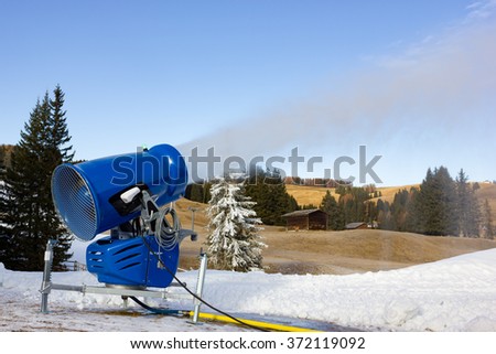 Cannon fires snow on the ski slopes