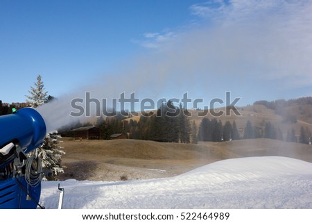 Cannon fires snow on the ski slopes