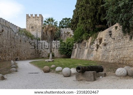 Cannon and trebuchet, catapult stones and walls in the moat of old town city of Rhodes, Greece