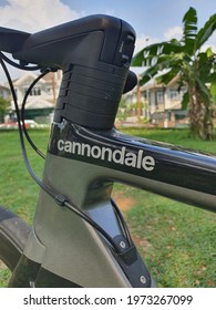 Cannondale SuperSix EVO Lightweight Bicycle Or Race Machine. Logo On Carbon Frame Bicycle. Aerodynamic Shape And Super Fast. Garden Park Background. Green. Malaysia. May 2021