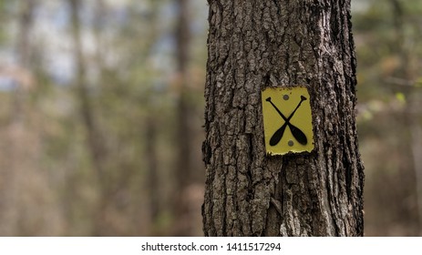 Canoe Portage Trail Marker Sign On A Tree In The Forest