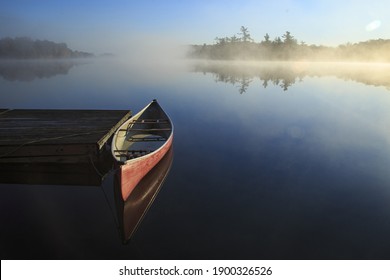 Canoe reflected in the still lake