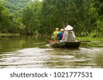 Canoe ride with the traditional paddlers rowing with their feet from Tam Coc, Ninh Bin, Vietnam
