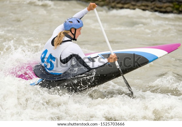 Canoe slalom athlete\
racing on white water