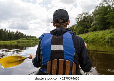 Canoeing On The Gauja River. View From The Back Of A Rower In A Life Jacket And With An Oar.