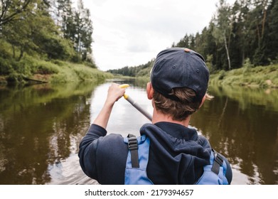 Canoeing On The Gauja River. View From The Back Of A Rower In A Life Jacket And With An Oar.