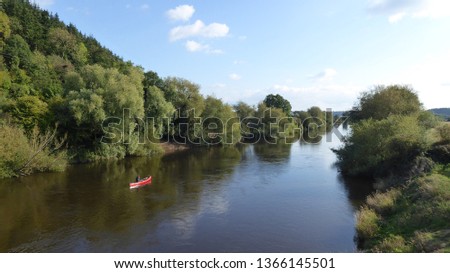 Canoeist on the river Wye, Herefordshire, England in the summertime.