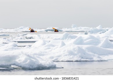 Canoeists Amid Icebergs On The Sea Ice Edge Of North Spitsbergen, Norway