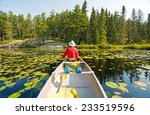 Canoer Relaxing in the Lily Pads in Dogtooth Lake in Ontario