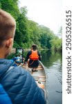 Canoer taking a photo whilst paddling down the river in Pembrokeshire Wales.