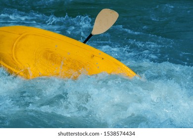 Canoer In A Yellow Kayak Flipping Over In Strong Rapids