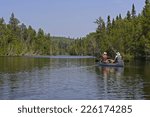 Canoers heading into Bit Lake in Quetico Provincial park