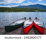 Canoes in Hyalite Reservoir on Hyalite Canyon in Bozeman, Montana, USA: A beautiful and tranquil water sport and recreational site at an elevation of 6,699 ft