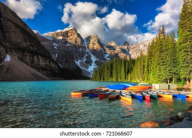 Canoes on Moraine lake at sunrise, Banff national park in the Rocky Mountains, Alberta, Canada.