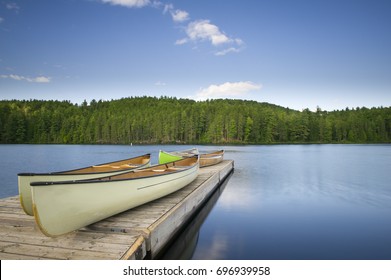 Canoes On A Wooden Dock In Muskoka Cottage Country 