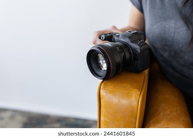 Canon EOS R6 camera on a leather couch - Powered by Shutterstock