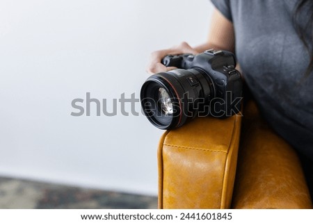 Canon EOS R6 camera on a leather couch