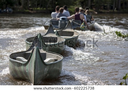 Canoos pulled back to the launch pad instead of paddling up the stream of Rio Miranda in Pantanal, Mato Grosso do Sul, Brazil