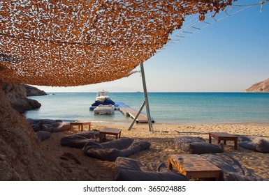 canopy on the sandy beach near the sea and sun loungers