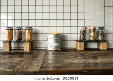 Cans with different grocery items on wooden kitchen table - Powered by Shutterstock