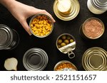 Cans with food, on a dark background.