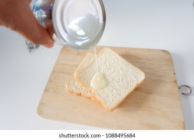 Cans Handles Poured Sweetened Condensed Milk On The Bread.