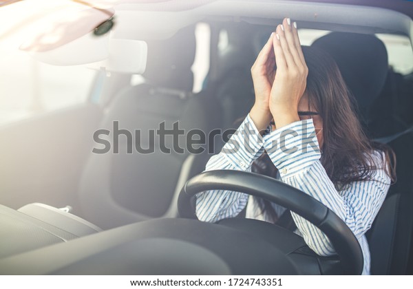 I can\'t\
believe I failed another driver\'s test. Cropped shot of a young\
woman looking stressed-out while sitting in her car. Female car\
driver tired and worried while\
driving