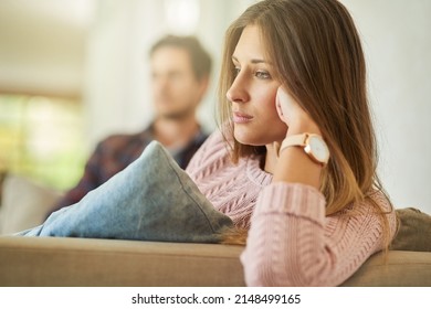 I Cant Believe Were Still Fighting About This. Shot Of An Unhappy Couple Sitting On The Couch At Home After A Fight.