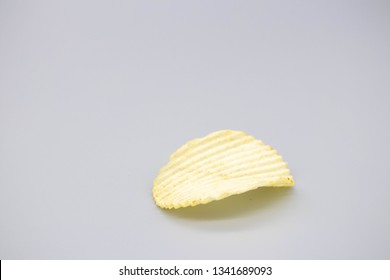 Can't Have Just One Single Potato Chip Ruffle On Gray Background Macro Horizontal