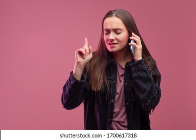 I Can't Hear You. The Girl With The Phone. Telephone Conversation, Young Woman On A Pink Background