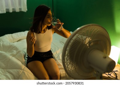 I Can't Sleep. Attractive Woman Feeling Thirsty And Warm In The Middle Of A Hot Night