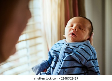 I Cant Stop Looking At Him , Even When He Sleeps. Shot Of A Tired Little Baby Boy Sleeping With His Eyes Closed While His Mother Holds Him In Her Hands At Home.