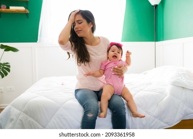 I Can't Take It Anymore. Tired And Upset Young Mom Feeling Exhausted With Her Crying New Born Baby  