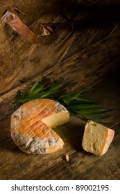 cantabrian matured cheese on aged wood background in vertical composition