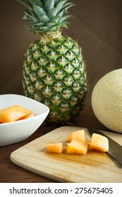 Cantalope And Pinapple On A Counter In The Morning Sun.