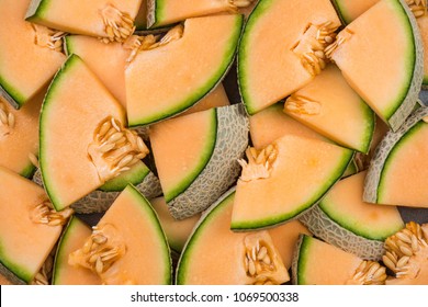 Cantaloupe melon slices, full frame food background.