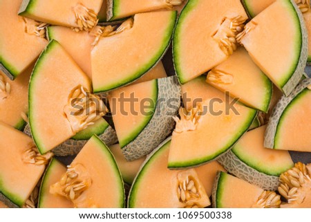 Cantaloupe melon slices, full frame food background.