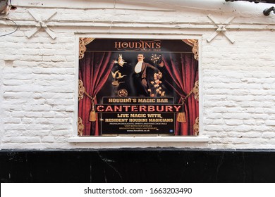 Canterbury, Kent/UK - February 22 2020: Advertising boards for Houdini's magic bar on St Peter's Street. One sign is mostly cream, the other colourful. Both feature Houdini. Set against white bricks.