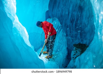 Canterbury, New Zealand - Dec 9, 2020: A Tour Leader Is Using The Ice Axe At The Blue Cave Under Tasman Glacier In Mt Cook National Park.