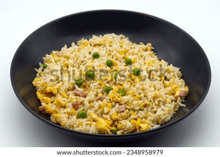 Cantonese Rice in a black dish isolated on white background.