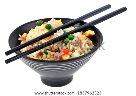 Cantonese rice bowl with Chinese chopsticks close-up on white background