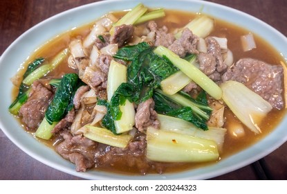 Cantonese style fried lean juicy beef with rice noodles in a fragrant soy based gravy. Fresh crunchy green vegetables added for balance and garnish. Simple and healthy meal as a catering concept. - Shutterstock ID 2203244323